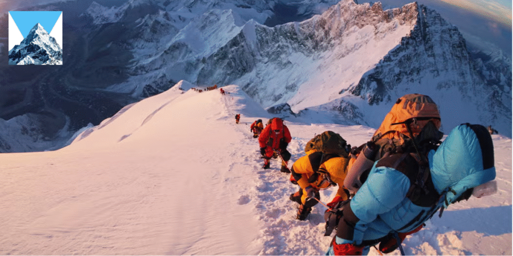 Climbers ascending snowy mountain peak